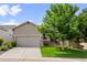 Charming home featuring a landscaped front yard, stone accents, and an attached two-car garage at 1051 Bramblewood Dr, Castle Pines, CO 80108