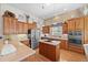Kitchen featuring a center island, stainless steel appliances, and ample cabinet space at 1051 Bramblewood Dr, Castle Pines, CO 80108