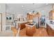 Open-concept kitchen with stainless steel appliances and an island with a cooktop at 1051 Bramblewood Dr, Castle Pines, CO 80108
