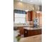 Close up of the kitchen including stainless steel appliances, island, and wood cabinets at 1051 Bramblewood Dr, Castle Pines, CO 80108