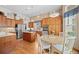 Eat-in kitchen featuring wood cabinets, stainless steel appliances, and a center island at 1051 Bramblewood Dr, Castle Pines, CO 80108