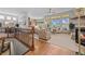 Bright living room with hardwood floors, a staircase, and an open floor plan at 1051 Bramblewood Dr, Castle Pines, CO 80108