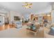 Bright living room featuring hardwood floors, a ceiling fan, and an open layout to the kitchen at 1051 Bramblewood Dr, Castle Pines, CO 80108