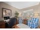 Comfortable home office space with hardwood floors, a desk, and relaxing sitting area at 1051 Bramblewood Dr, Castle Pines, CO 80108
