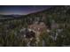 Enchanting aerial view of the house set against a starlit night sky at 8451 London Ln, Conifer, CO 80433