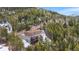 Expansive aerial view of the house nestled amidst a lush forest at 8451 London Ln, Conifer, CO 80433