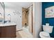 Well lit bathroom featuring tile flooring, a vanity, toilet, and shower/tub combo at 8451 London Ln, Conifer, CO 80433
