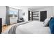 Bedroom featuring wood floors, white walls, mountain views and a sliding barn door at 8451 London Ln, Conifer, CO 80433