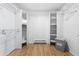 Walk in closet with white shelving and bars for ample storage, with hardwood floors at 8451 London Ln, Conifer, CO 80433