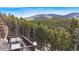 Relaxing deck with outdoor furniture, offering breathtaking mountain views at 8451 London Ln, Conifer, CO 80433