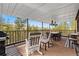 Covered deck with an outdoor dining area and beautiful views of the mountains at 8451 London Ln, Conifer, CO 80433