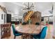 Dining area with round wood table under a modern light fixture in a bright, open home at 8451 London Ln, Conifer, CO 80433