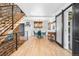 Bright dining room featuring hardwood floors, modern light fixture and adjacent stone staircase at 8451 London Ln, Conifer, CO 80433