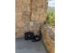 An EV charger and outdoor outlet on a stone patio at 8451 London Ln, Conifer, CO 80433
