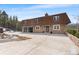 Stunning stone home with a large driveway and attached garage at 8451 London Ln, Conifer, CO 80433