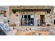 Close-up of a stone fireplace with a wooden beam and a cozy fire burning at 8451 London Ln, Conifer, CO 80433