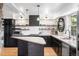 Bright kitchen features a center island, stainless appliances, and open shelving at 8451 London Ln, Conifer, CO 80433