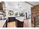 Open kitchen features a center island, stainless appliances, stone accents and views at 8451 London Ln, Conifer, CO 80433