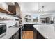 Bright kitchen featuring stainless appliances, stone countertops, and floating shelves at 8451 London Ln, Conifer, CO 80433