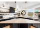 Bright kitchen features a center island, stainless appliances, and open shelving at 8451 London Ln, Conifer, CO 80433