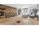 Cozy living room with stone fireplace, hardwood floors, and comfortable seating at 8451 London Ln, Conifer, CO 80433