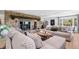 Open-concept living room with stone fireplace, comfortable seating, and hardwood floors at 8451 London Ln, Conifer, CO 80433