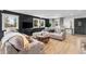 Elegant living room with a black accent wall, large windows, and stylish furniture at 8451 London Ln, Conifer, CO 80433