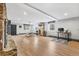 Open living room with hardwood floors, stone fireplace, and modern decor at 8451 London Ln, Conifer, CO 80433