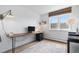 Bright office space with wood floors, a wooden desk and a picturesque mountain view at 8451 London Ln, Conifer, CO 80433