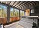 Outdoor patio with a wooden deck, covered hot tub and views of the forest at 8451 London Ln, Conifer, CO 80433