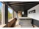 Outdoor patio with a wooden deck, covered hot tub and views of the forest at 8451 London Ln, Conifer, CO 80433