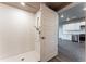 Bright bathroom features a tiled shower and modern fixtures next to the kitchen at 12983 W Ida Ave # 304, Littleton, CO 80127