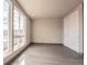 Bright bedroom with large window, a closet, and modern gray flooring at 12983 W Ida Ave # 304, Littleton, CO 80127
