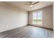 Bedroom with large window offering scenic views and a modern ceiling fan at 12983 W Ida Ave # 304, Littleton, CO 80127