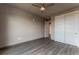 This bedroom features modern gray flooring, a ceiling fan, and a closet at 12983 W Ida Ave # 304, Littleton, CO 80127