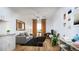 Living room features a modern ceiling fan, hardwood floors, and neutral decor at 12983 W Ida Ave # 304, Littleton, CO 80127