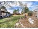 Spacious backyard with a covered patio, landscaping and grass at 13036 Clayton Ct, Thornton, CO 80241