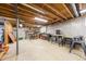 Large unfinished basement with exposed wood beam ceiling and concrete floor at 13036 Clayton Ct, Thornton, CO 80241