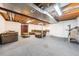 Spacious basement featuring carpeting, a sectional couch and exposed ceiling at 13036 Clayton Ct, Thornton, CO 80241