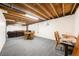 Unfinished basement with wooden ceiling beams, carpeting, and a Gathering room area at 13036 Clayton Ct, Thornton, CO 80241