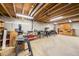 Unfinished basement with a workbench area, bright lighting, and a concrete floor at 13036 Clayton Ct, Thornton, CO 80241