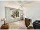 Bedroom with neutral walls, carpet, ceiling fan, and a large window overlooking trees at 13036 Clayton Ct, Thornton, CO 80241