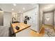 Well-lit kitchen with hardwood floors, white cabinets, and modern appliances at 13036 Clayton Ct, Thornton, CO 80241