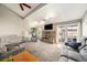 Spacious living room featuring a brick fireplace, vaulted ceilings, and access to the outdoor patio at 13036 Clayton Ct, Thornton, CO 80241