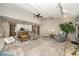 Open living room with vaulted ceilings that leads to a well-lit kitchen and cozy fireplace at 13036 Clayton Ct, Thornton, CO 80241