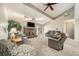 Bright living room with vaulted ceilings, a brick fireplace, and sliding glass doors to the backyard at 13036 Clayton Ct, Thornton, CO 80241
