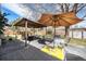 Back patio with multiple seating areas, covered table, and lounge furniture at 13036 Clayton Ct, Thornton, CO 80241