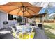 Back patio with a covered table and seating, and a yellow rug at 13036 Clayton Ct, Thornton, CO 80241