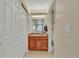 Bathroom with wood vanity, ample cabinet space, and shower behind the door at 2804 S Heather Gardens Way # A, Aurora, CO 80014