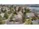Panoramic aerial of a neighborhood with mature trees, well-maintained lawns, and a tranquil lake in the background at 2032 W Nantucket Ct, Littleton, CO 80120